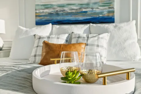 a living room with furniture a bookshelf and a large window