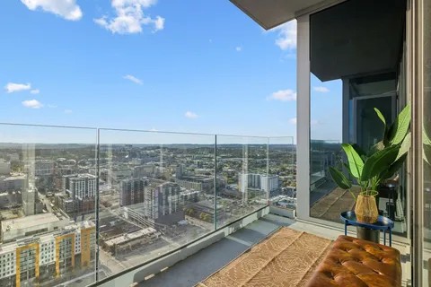 an aerial view of a balcony with chairs and a table