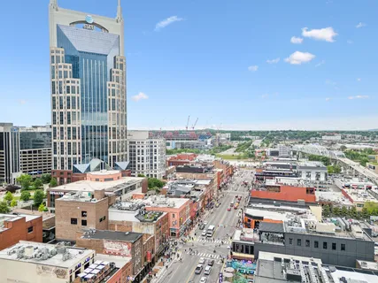 a living room with furniture and a floor to ceiling window