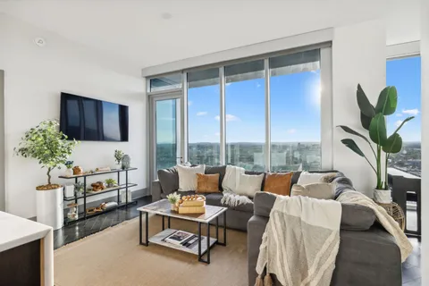 a kitchen with a stove a sink a center island and cabinets