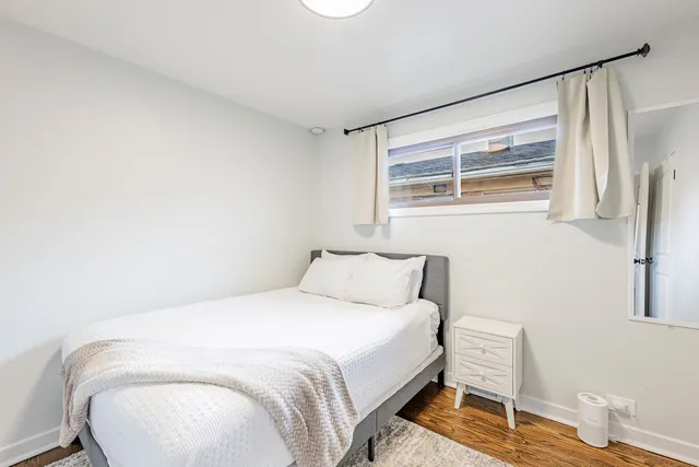 a bedroom with a bed and a chair