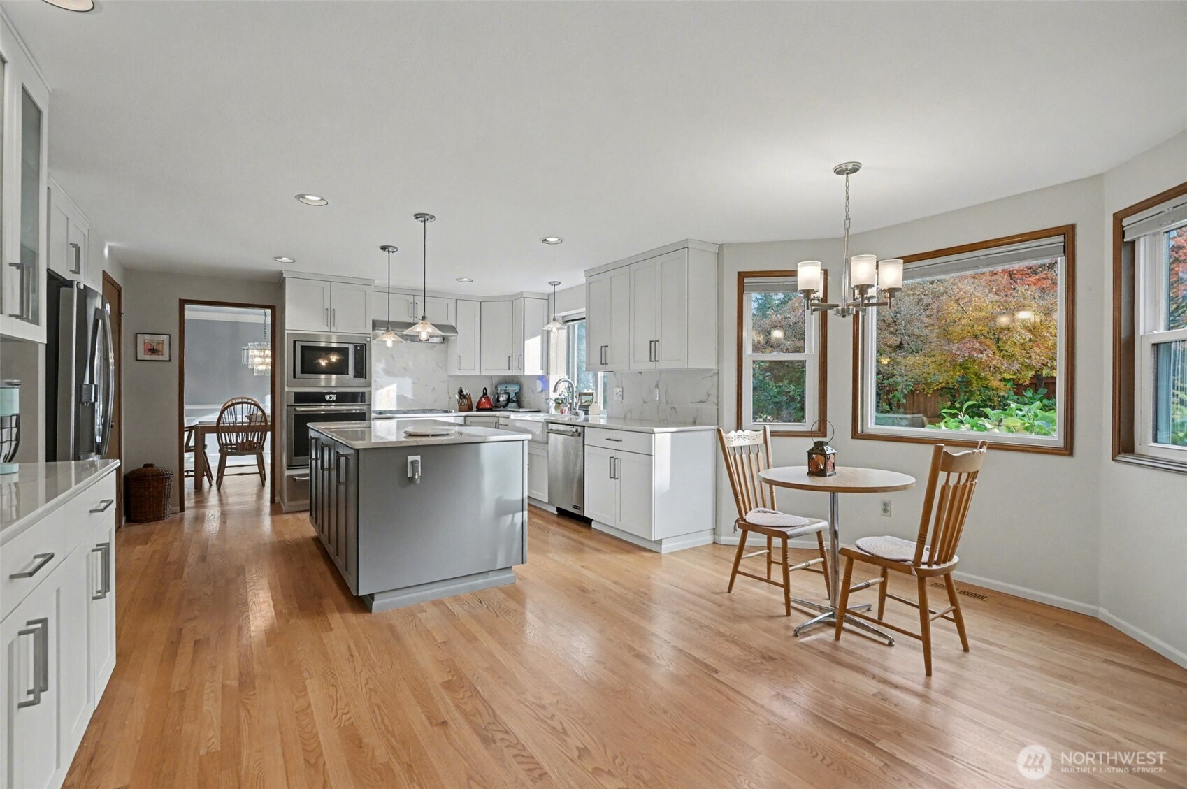15823 Southeast 182nd Place Renton, WA 98058 - Photo 12 of 30 a living room with stainless steel appliances granite countertop furniture wooden floor and a kitchen view