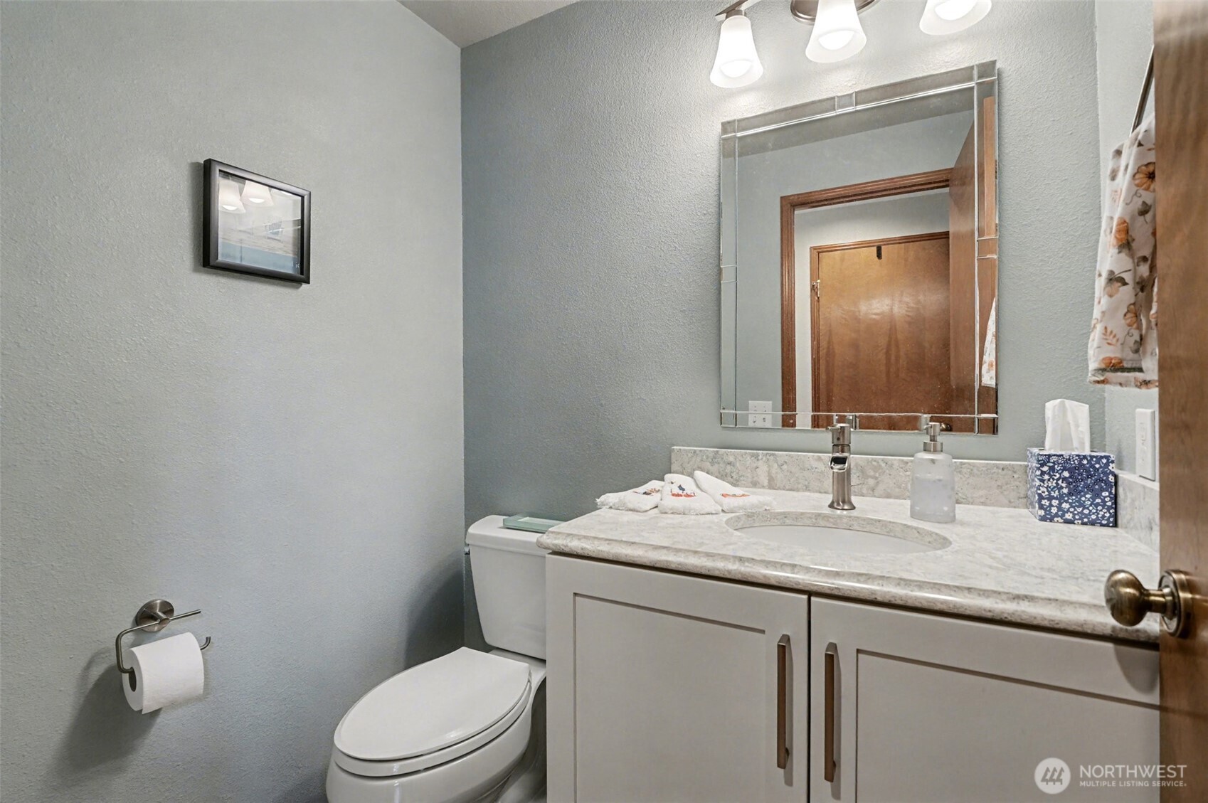 15823 Southeast 182nd Place Renton, WA 98058 - Photo 16 of 30 a bathroom with a toilet sink vanity and mirror