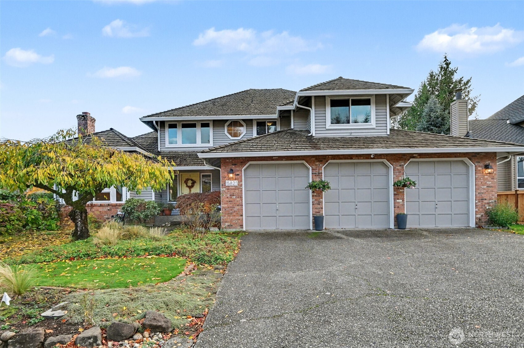 15823 Southeast 182nd Place Renton, WA 98058 - Photo 2 of 30 a front view of a house with a yard and garage