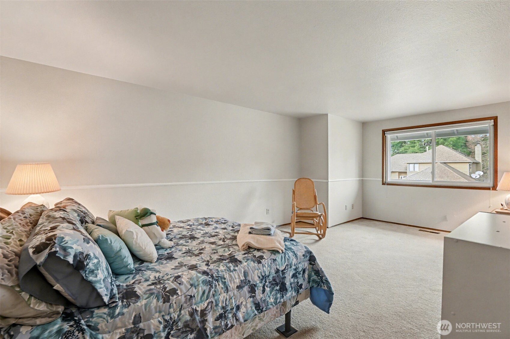 15823 Southeast 182nd Place Renton, WA 98058 - Photo 23 of 30 a bed sitting in a bedroom next to a window