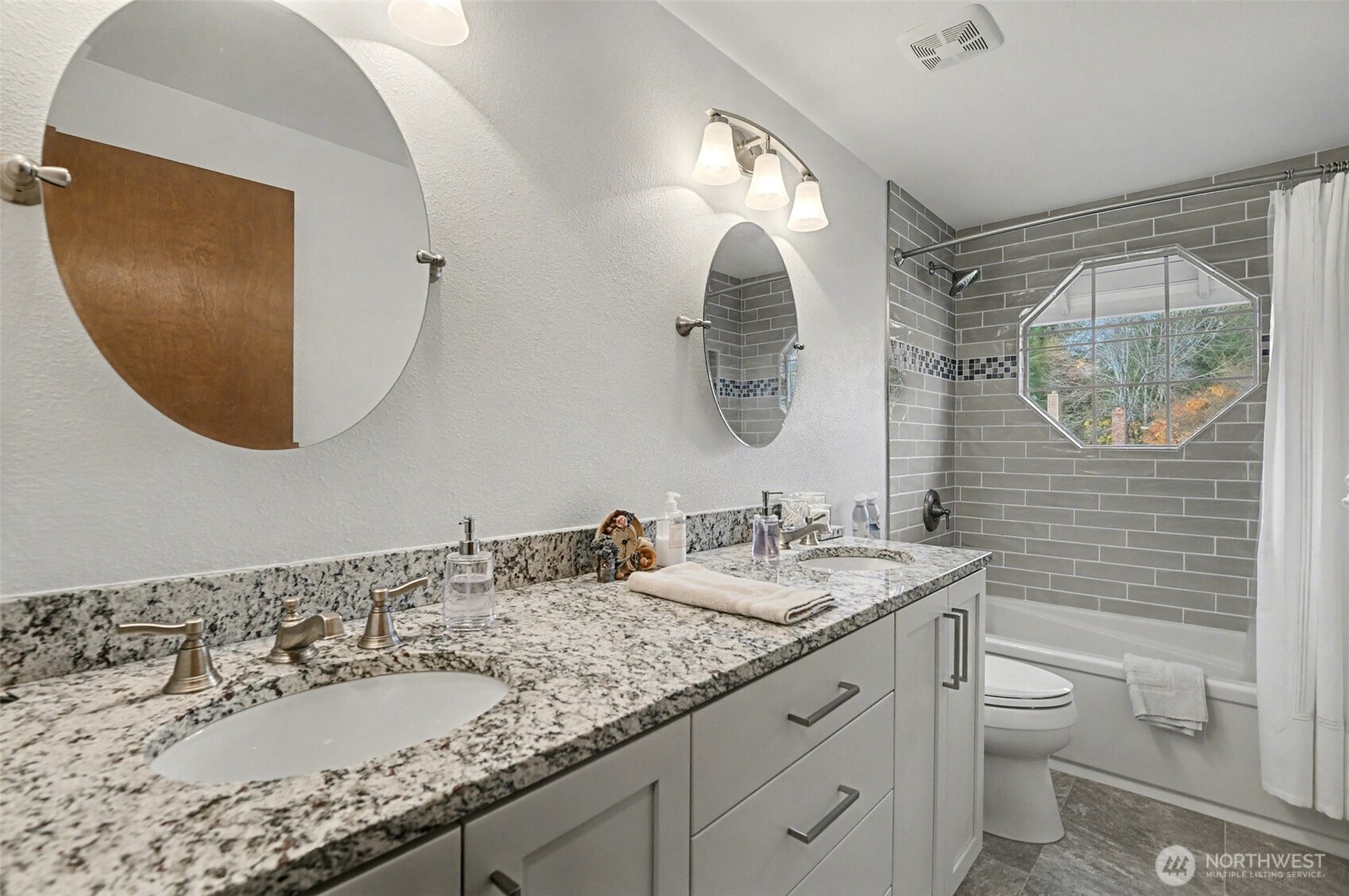 15823 Southeast 182nd Place Renton, WA 98058 - Photo 24 of 30 a bathroom with a granite countertop toilet a sink and a mirror