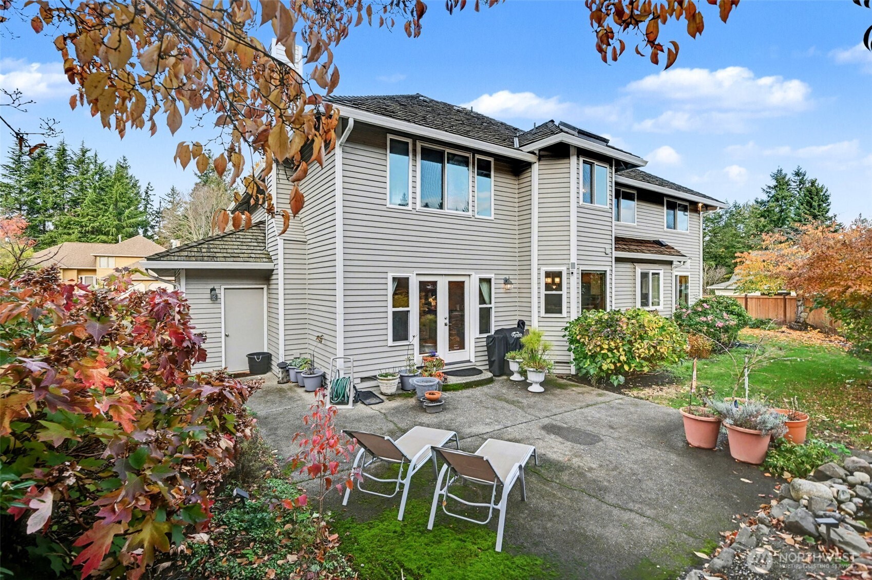15823 Southeast 182nd Place Renton, WA 98058 - Photo 25 of 30 a patio with table and chairs and potted plants