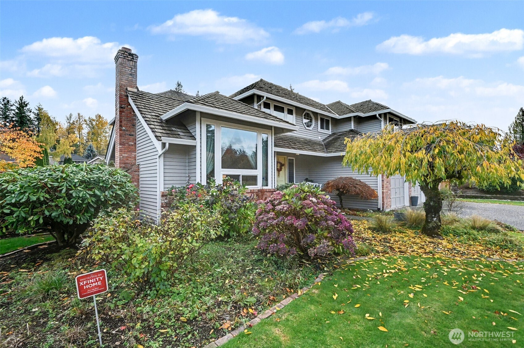 15823 Southeast 182nd Place Renton, WA 98058 - Photo 3 of 30 a front view of a house with a yard and garage