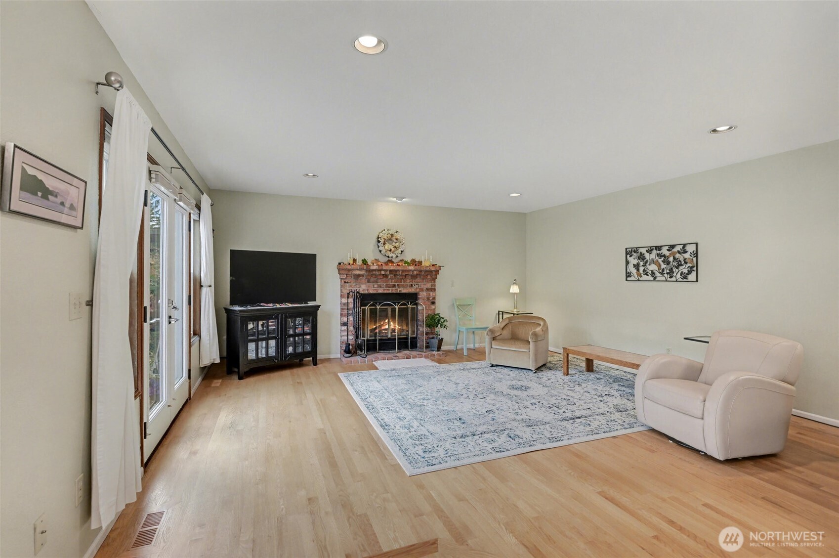 15823 Southeast 182nd Place Renton, WA 98058 - Photo 10 of 30 a living room with furniture and a flat screen tv