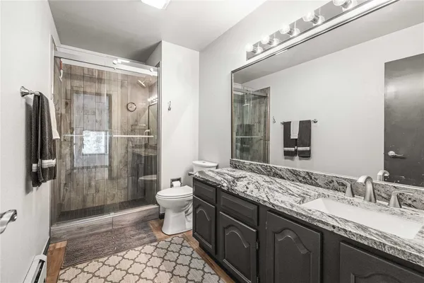 a living room with furniture a bed and a large window