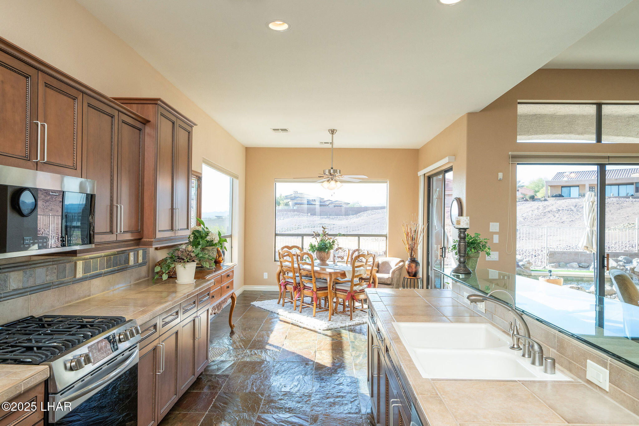 3553 North Swilican Bridge Road Lake Havasu City, AZ 86404 - Photo 16 of 104 a large kitchen with granite countertop a large window and a counter space