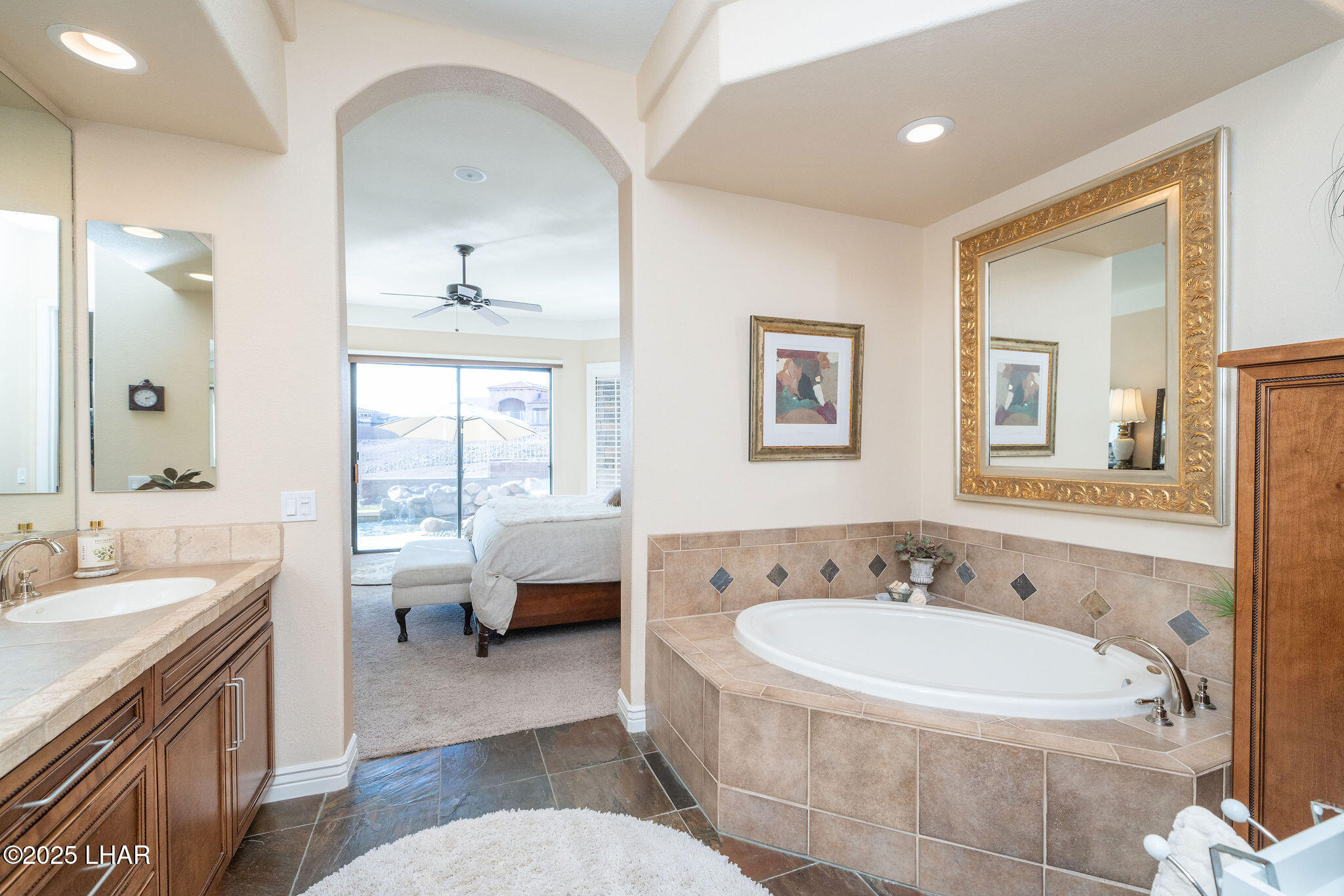 3553 North Swilican Bridge Road Lake Havasu City, AZ 86404 - Photo 30 of 104 a spacious bathroom with a tub sink and mirror