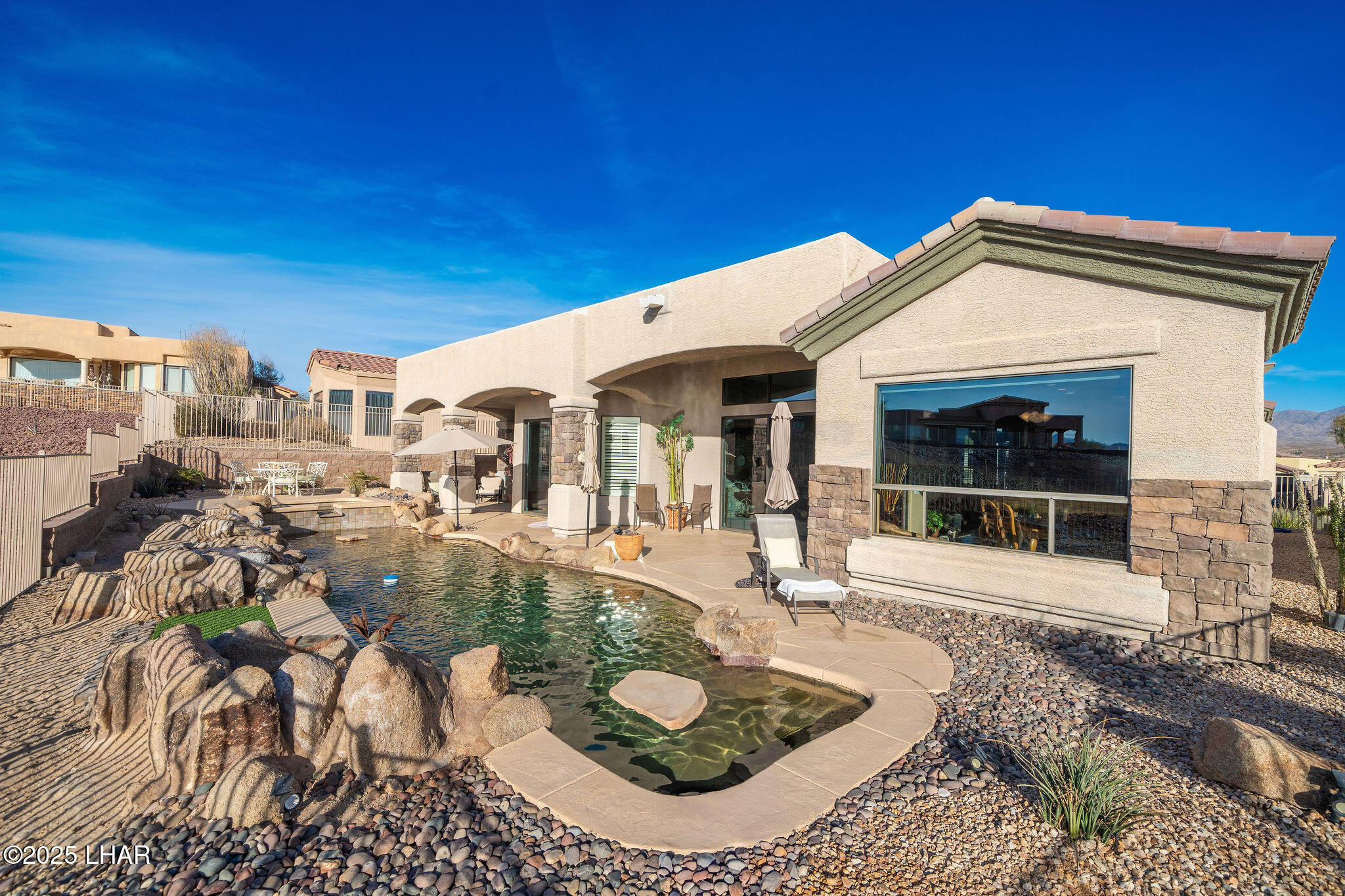 3553 North Swilican Bridge Road Lake Havasu City, AZ 86404 - Photo 80 of 104 a view of a white house with a swimming pool and outdoor seating