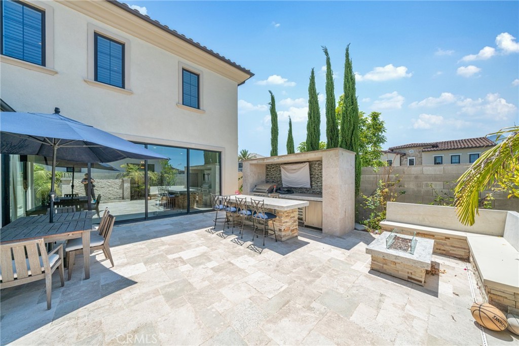 52 Eider Run Irvine, CA 92618 - Photo 6 of 46 a outdoor space with patio the couches and a fireplace