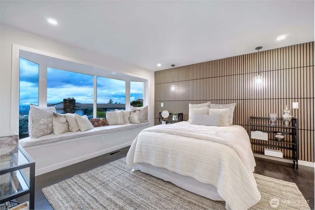 a bedroom with a large bed and a large window