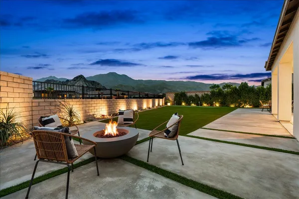a view of a chairs and table in patio with a lake view