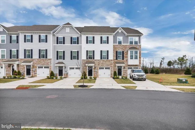 a view of the house with a swimming pool and sitting area