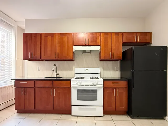 a kitchen with a stove top oven and cabinets