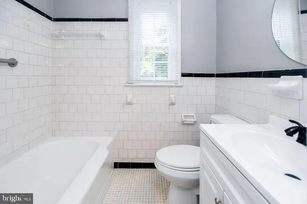 a bathroom with a sink a toilet and bathtub