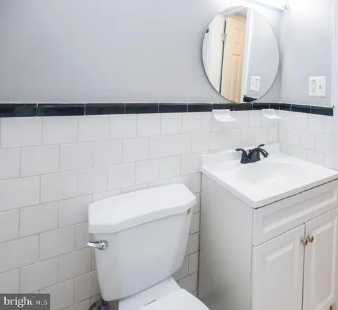 a bathroom with a sink a mirror and a toilet