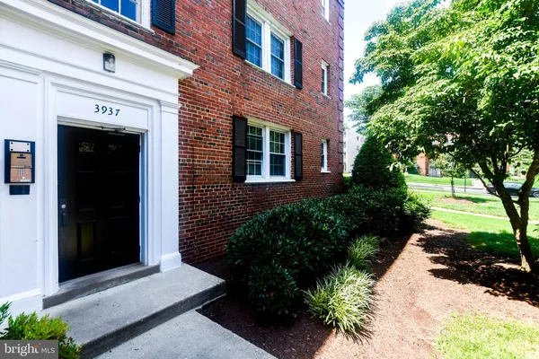 a view of a brick house with a yard