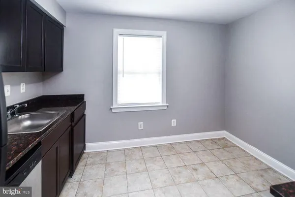 a kitchen with a sink a stove and cabinets