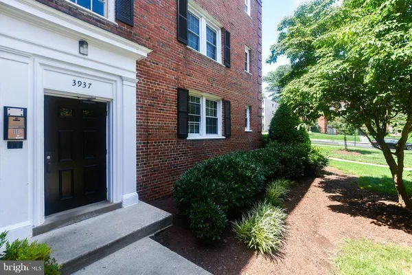 a view of a brick house with a yard