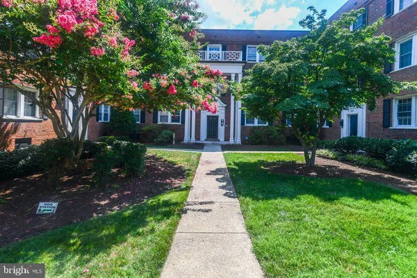 a front view of a house with a yard and fountain
