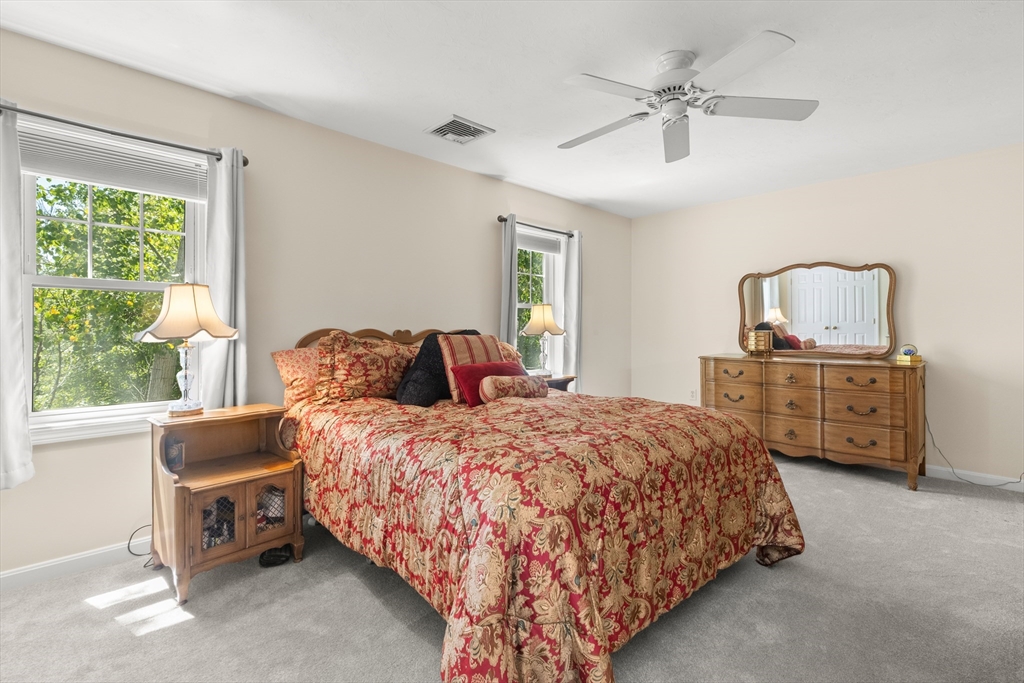 35 Collins Street, Unit 87 Danvers, MA 01923 - Photo 11 of 28 a bedroom with a bed a dresser and a window