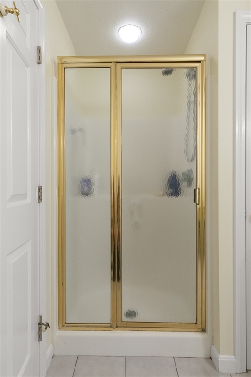 35 Collins Street, Unit 87 Danvers, MA 01923 - Photo 15 of 28 a bathroom with a glass shower door