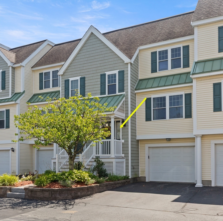 35 Collins Street, Unit 87 Danvers, MA 01923 - Photo 25 of 28 a front view of a house with a yard and potted plants