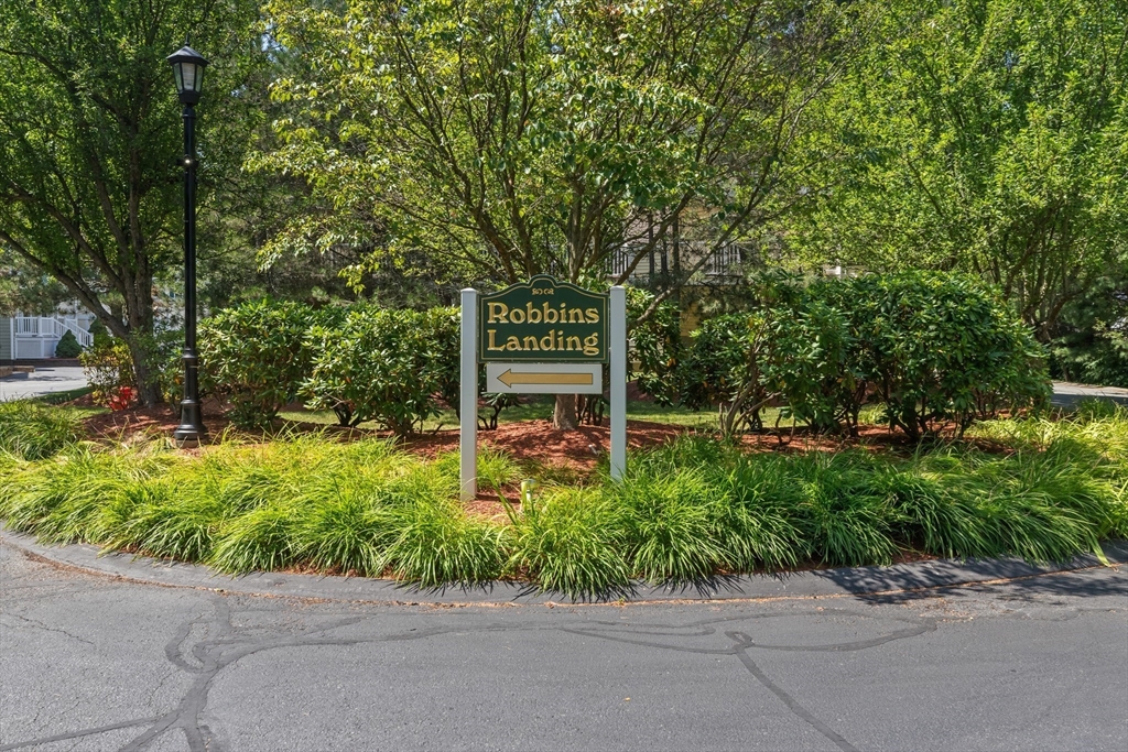35 Collins Street, Unit 87 Danvers, MA 01923 - Photo 28 of 28 a sign that is sitting in front of a house with plants