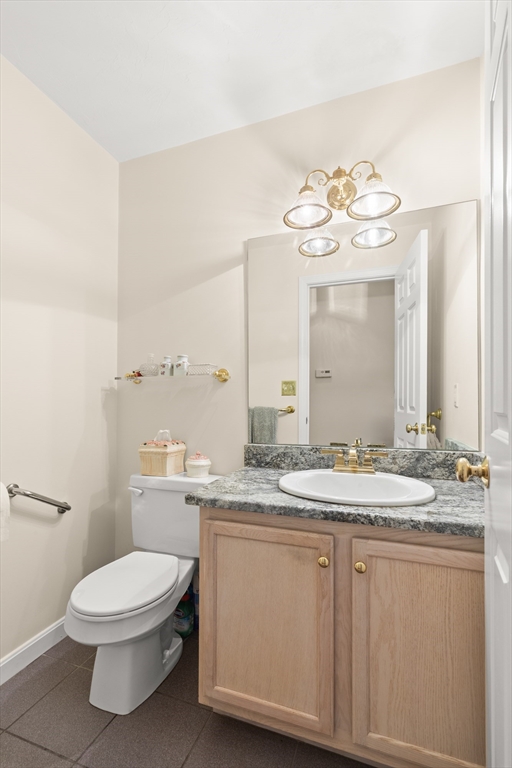 35 Collins Street, Unit 87 Danvers, MA 01923 - Photo 10 of 28 a bathroom with a granite countertop toilet sink and mirror