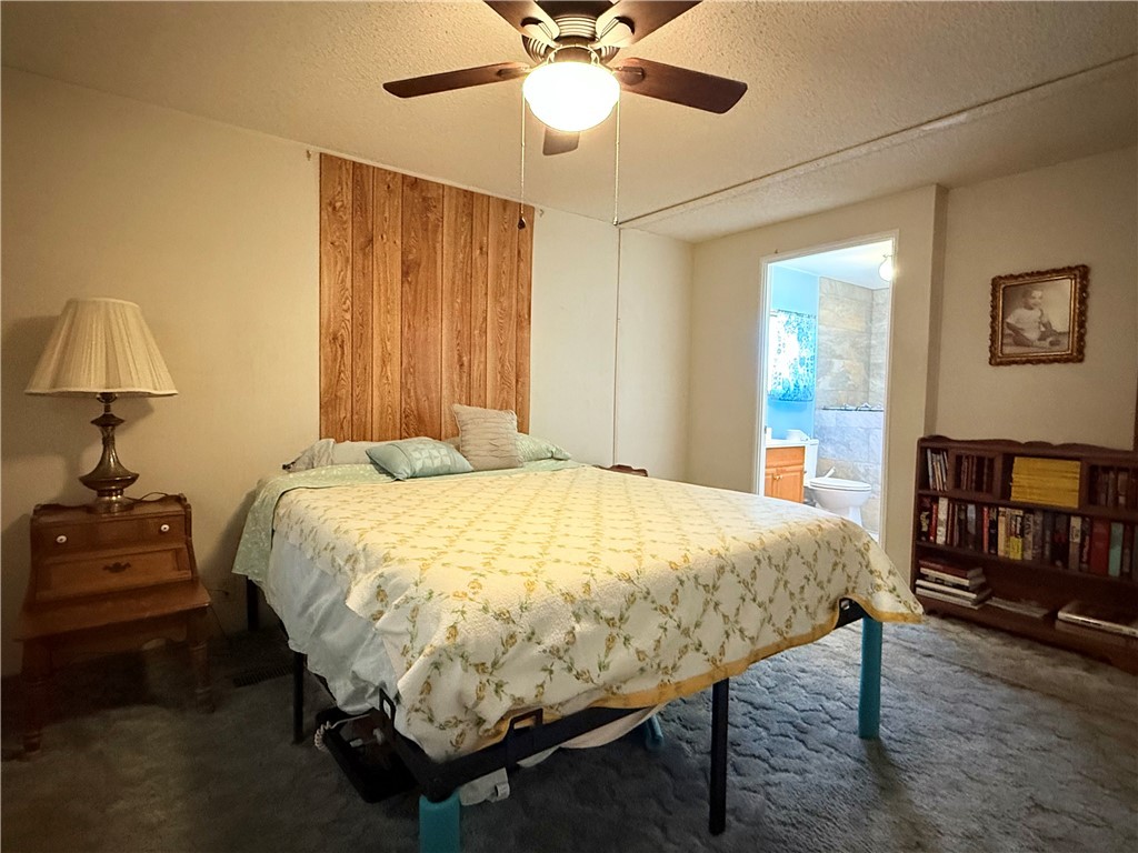 1637 Talc Road Bullhead City, AZ 86442 - Photo 20 of 37 Carpeted bedroom with ceiling fan and a textured ceiling
