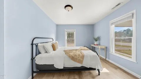 a bedroom with a bed and window
