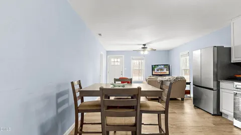 a dining room with furniture and window