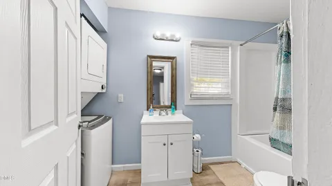 a bathroom with a sink mirror and a bathtub