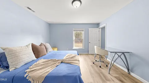 a bedroom with a bed and window