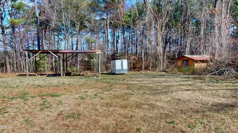 a view of outdoor space with deck and trees