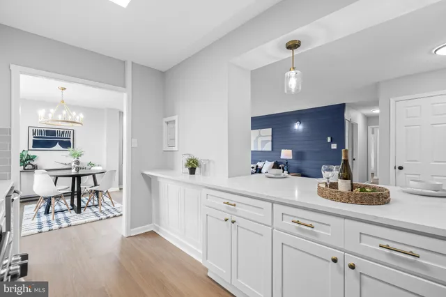 a kitchen with white cabinets and counter space