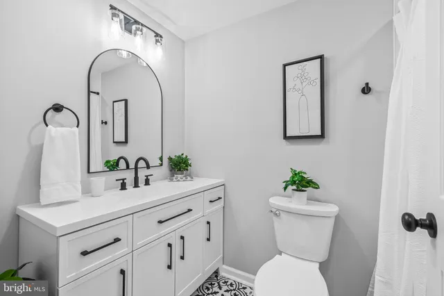 a bathroom with a toilet sink and mirror