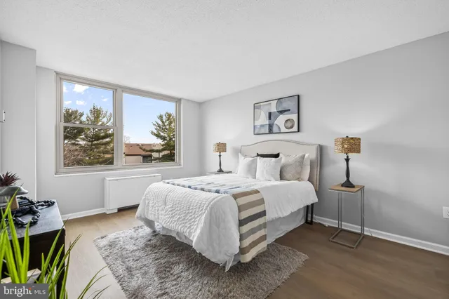 a bed room with a bed and a painting on the wall