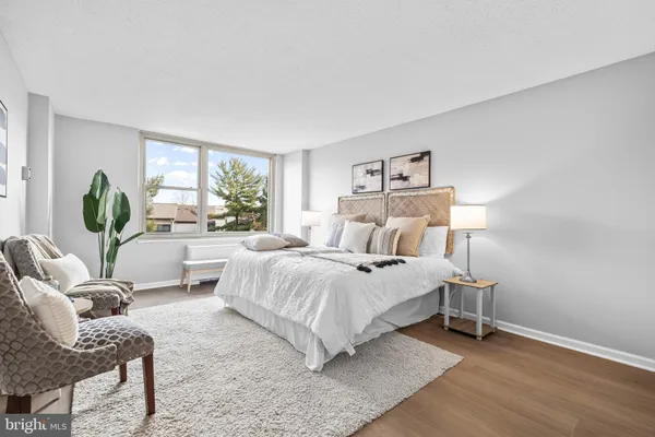 a bedroom with a bed and a couch