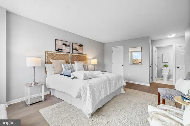 a bedroom with a bed and a lamp