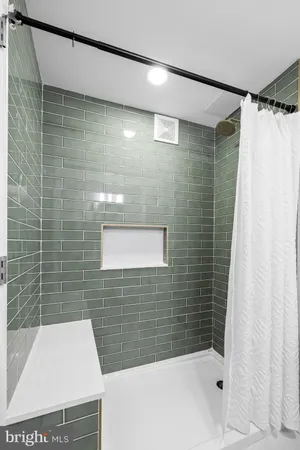 a bathroom with a shower and a sink