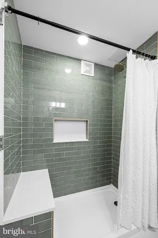 a bathroom with a shower and a sink