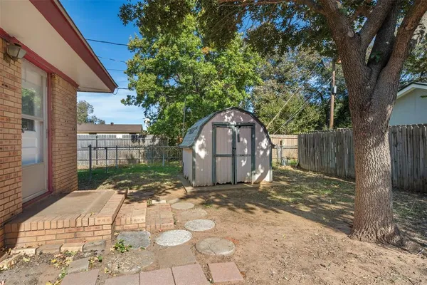 a view of a small yard with wooden fence