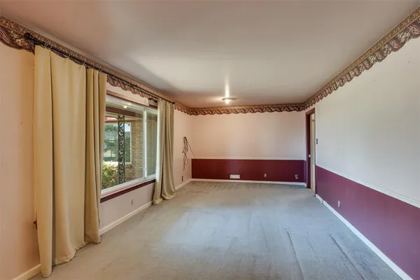 a view of an empty room with windows