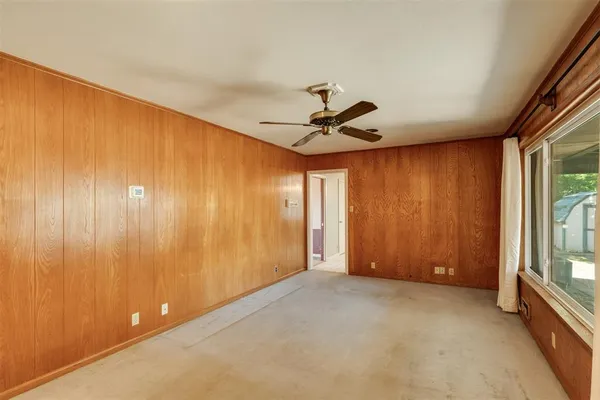 a view of an empty room and a window