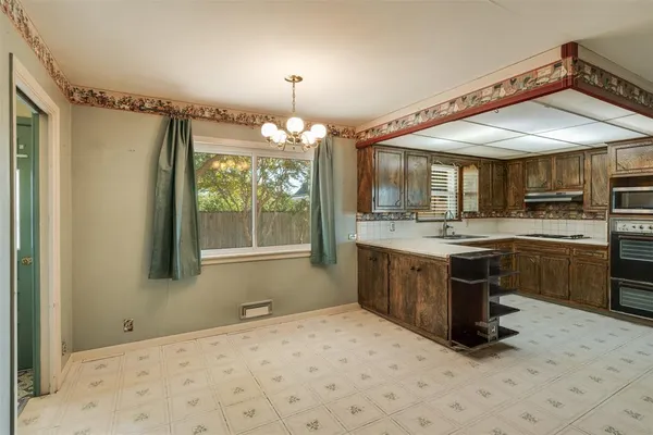 a kitchen with a sink cabinets and window